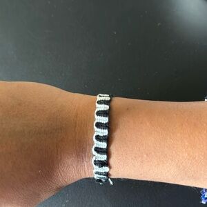 Handmade woven bracelet. Black and white, squiggle pattern.